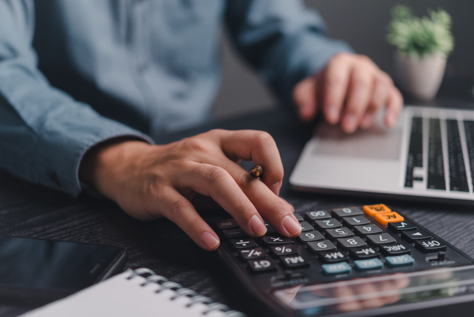 Businessman using calculator bookkeeping payroll and budget tax. Business document finance accounting investment Businessman using calculator bookkeeping payroll and budget tax. Business document finance accounting investment
