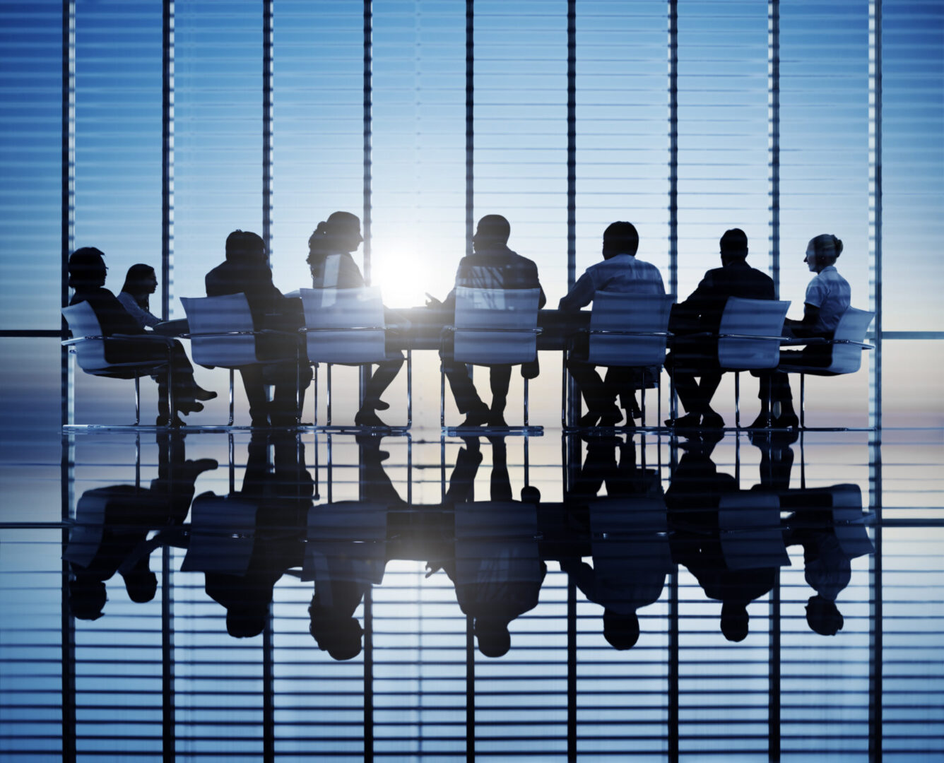 Silhouettes Of Business People In A Conference Room Silhouettes of business people in a conference room.